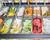 Display of assorted ice creams in metal tubs in a shop or ice cream parlour.
