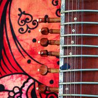 Close-up of an old sitar against a colorful background. (music, India)