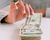 Mixed race woman taking money from stack