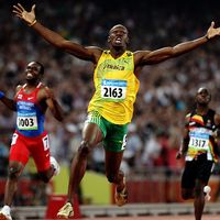 Usain Bolt of Jamaica reacts after breaking the world record with a time of 19.30 to win the gold medal as Churandy Martina (left) of Netherlands Antilles and Brian Dzingai of Zimbabwe come in after him in the Men's 200m Final at the National Stadium during Day 12 of the Beijing 2008 Olympic Games on August 20, 2008 in Beijing, China. (Summer Olympics, track and field, athletics)