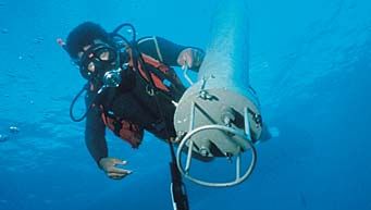 Research diver deploying self-contained instrument package.