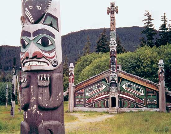 Tlingit community house and totem poles