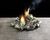 Pile of crumpled and smoldering hundred dollar bills.